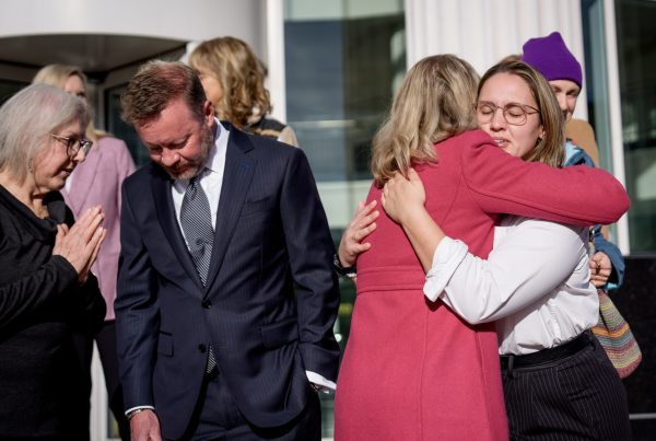 Emma Petty-Addams, co-executive director of Mormon Women for Ethical Government, and Elizabeth Rasmussen, executive director of Better Boundaries, who represent two groups that sued the Utah Legislature over their congressional maps, embrace after a press conference outside the Third District Courthouse in Salt Lake City on Tuesday, Nov. 11, 2025. Late the night before, 3rd District Judge Dianna Gibson ruled in favor of the plaintiffs, choosing their submitted map to be used in the 2026 elections. (Photo by Spenser Heaps for Utah News Dispatch)