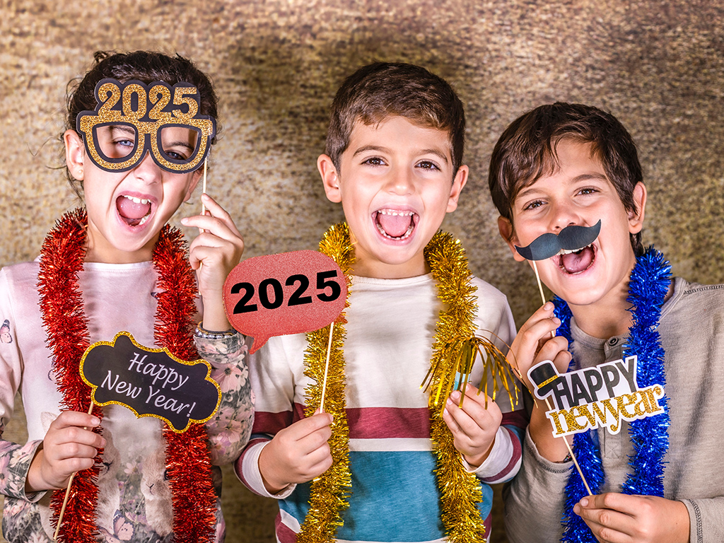Three kids celebrating new year's