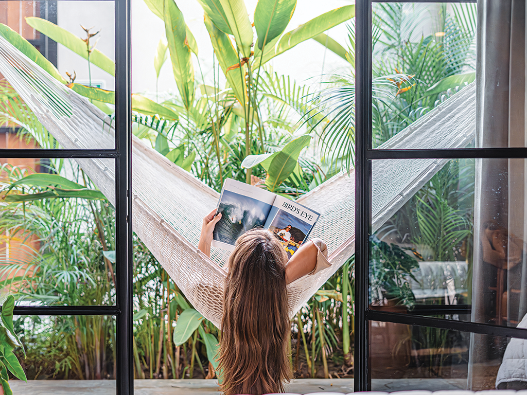 woman reading in a hammock, Alma Surf Lodge, Punta de Mita, Mexico