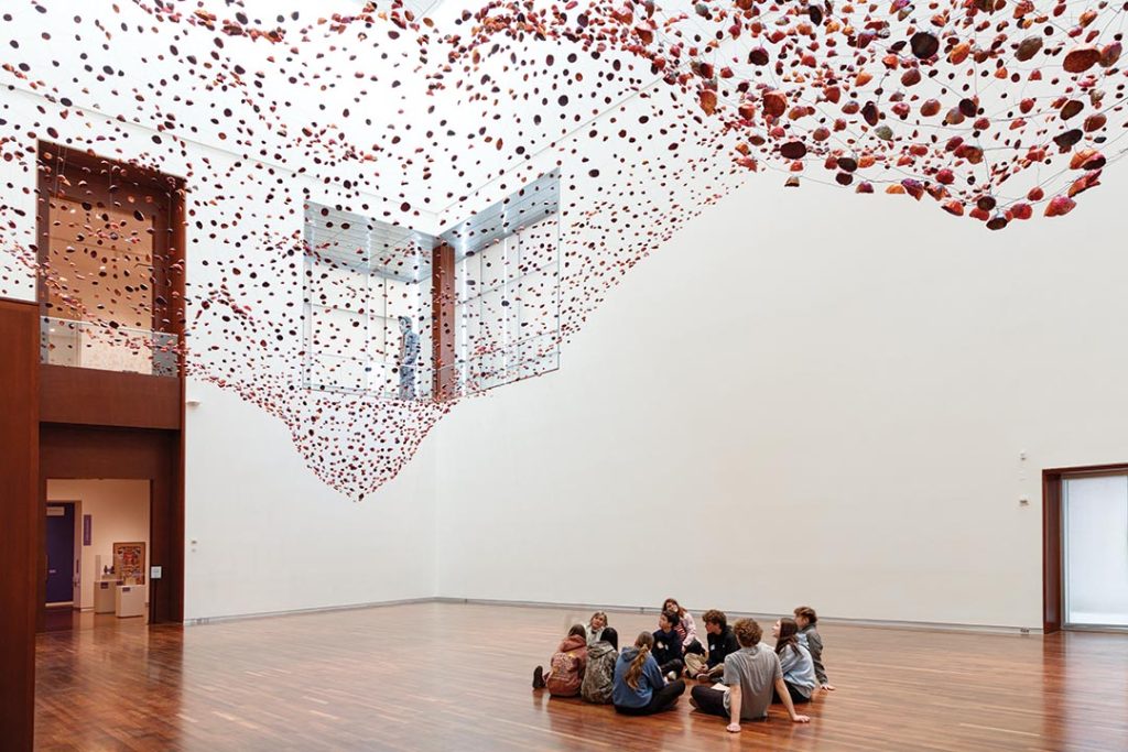 Installation views of "Stone on Boundary" by Yasuaki Onishi, a site specific installation in the Utah Museum of Fine Arts in the G.W. Anderson Family Great Hall. Yasuaki Onishi, Stone on Boundary, 2025, copper foils, magnets, and wire. UMFAL20205.3.1.