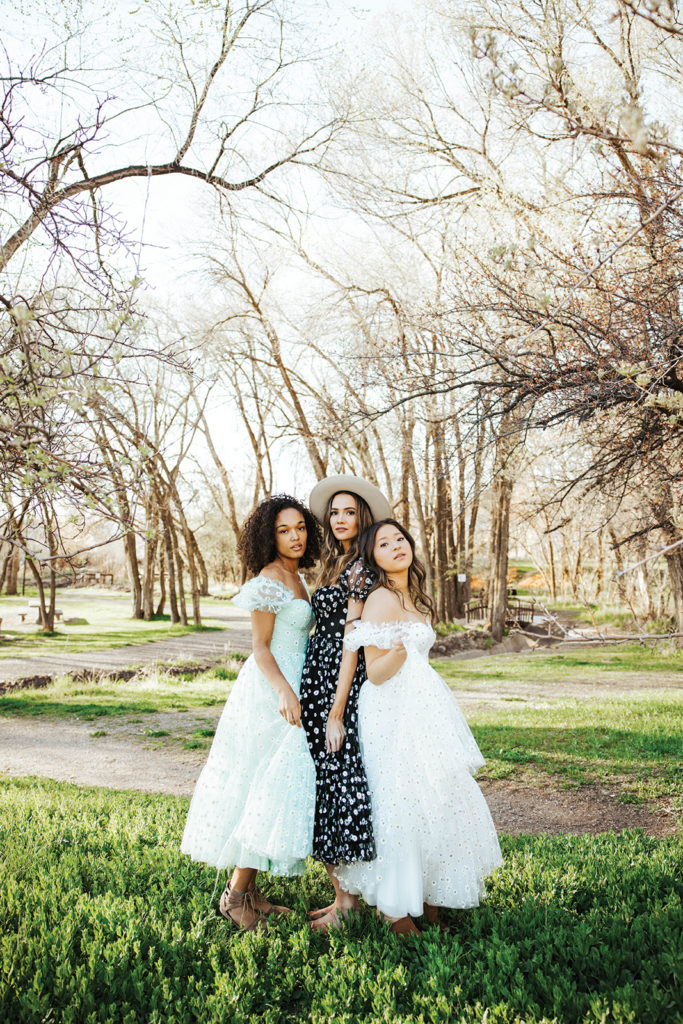 Three models in summer dresses from Ava Gowns