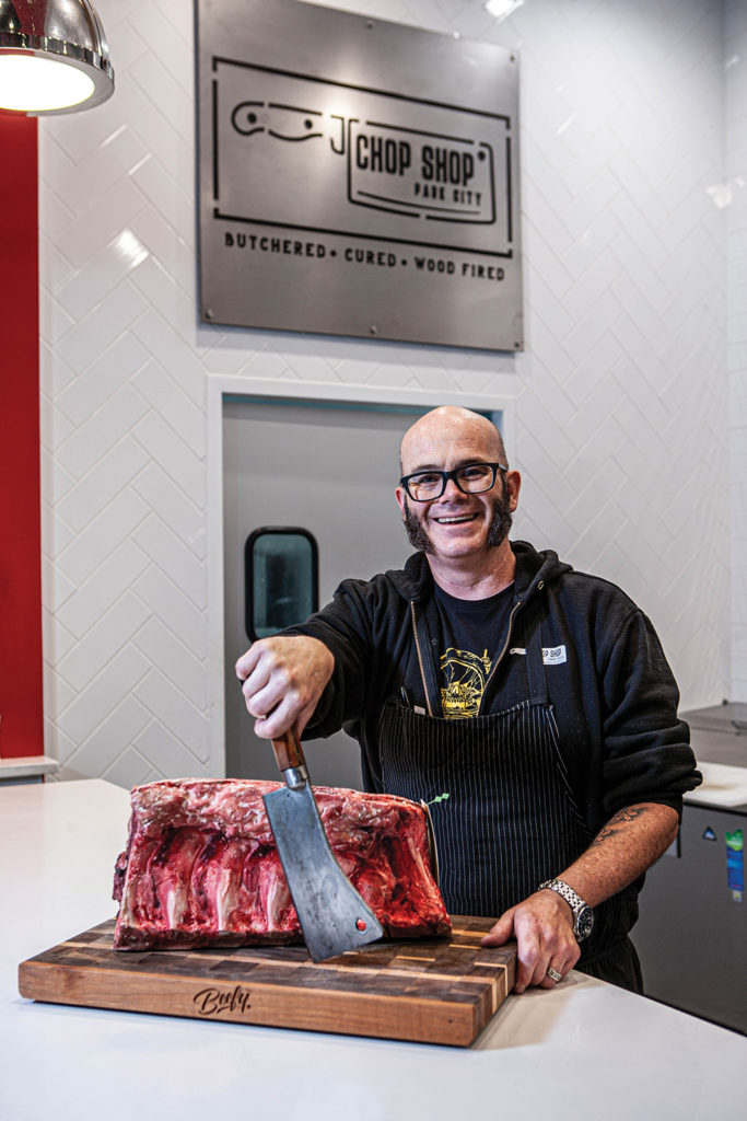 John Courtney, owner of Chop Shop, butchering meat in his store