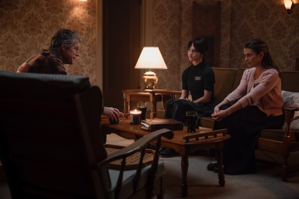 Hugh Grant, Chloe East, Sophie Thatcher in A24's "Heretic" (2024). (Photo credit: Kimberley French; courtesy: A24 Films)