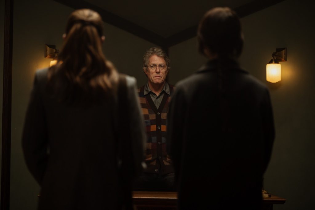 Chloe East, Hugh Grant, Sophie Thatcher in A24's "Heretic" (2024). (Photo credit: Kimberley French; courtesy: A24 Films)