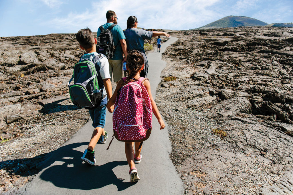 A family hiking Craters of the Moon National Monument & Preserve in Idaho
