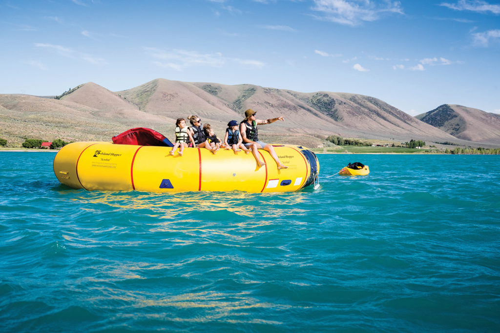 Family sits on water trampoline, Bear Lake State Park in Idaho