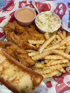 Raising Cane's Box Combo with chicken fingers, fries, coleslaw, Texas toast and Cane's sauce
