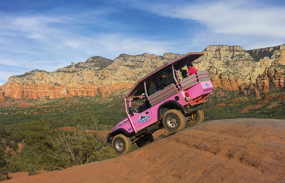 pink jeep on broken arrow slick rock in Sedona, Arizona