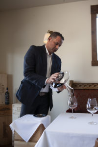 Marco Stevanoni pours wine into a glass at Veneto