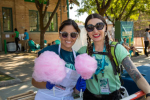 Volunteer Ana Valdemoros and Executive Director Angela H. Brown serve cotton candy