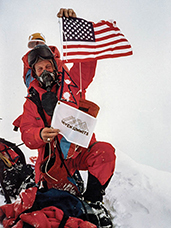 Dick Bass, co-founder of Snowbird, on top of snowy peak.