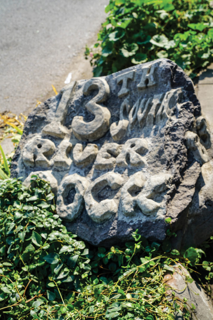 Old street sign carved in stone marking 13th South, where the river flowed.